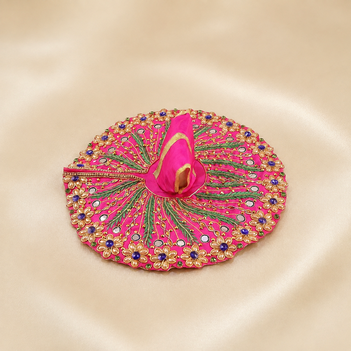 Bright pink Laddu Gopal dress with mirror work, gold floral embroidery, green leaf detailing and purple stones