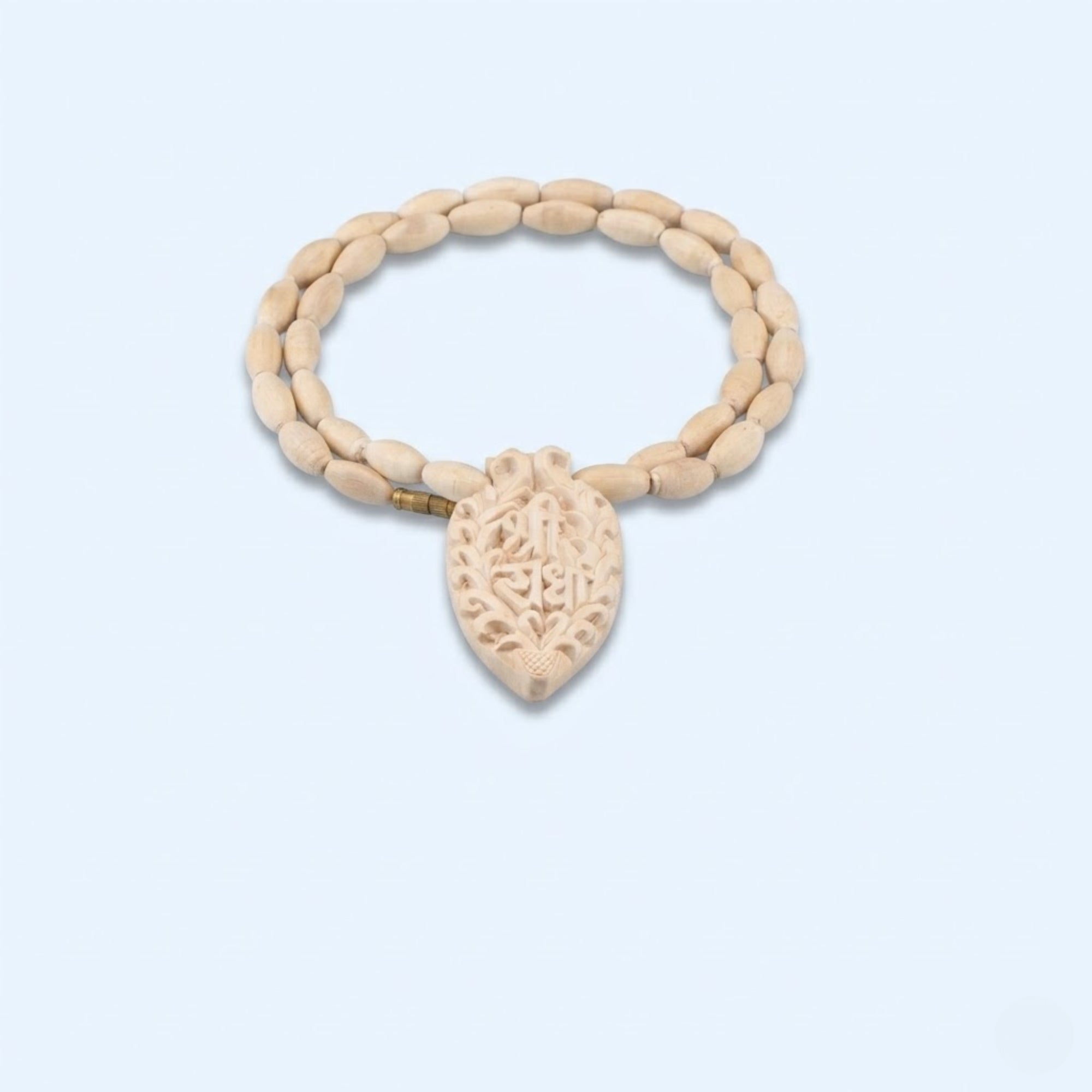 Close up view of the intricately carved Shri Radha name pendant made from pure Tulsi wood
