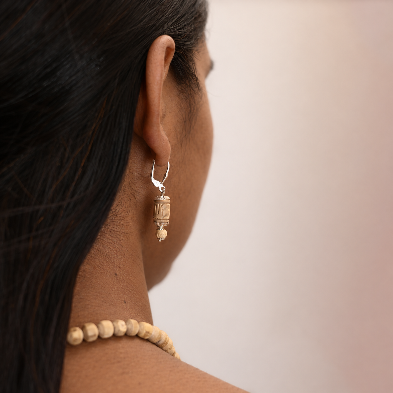 Tulsi drop earring with a carved barrel bead, small round bead and silver-toned fittings