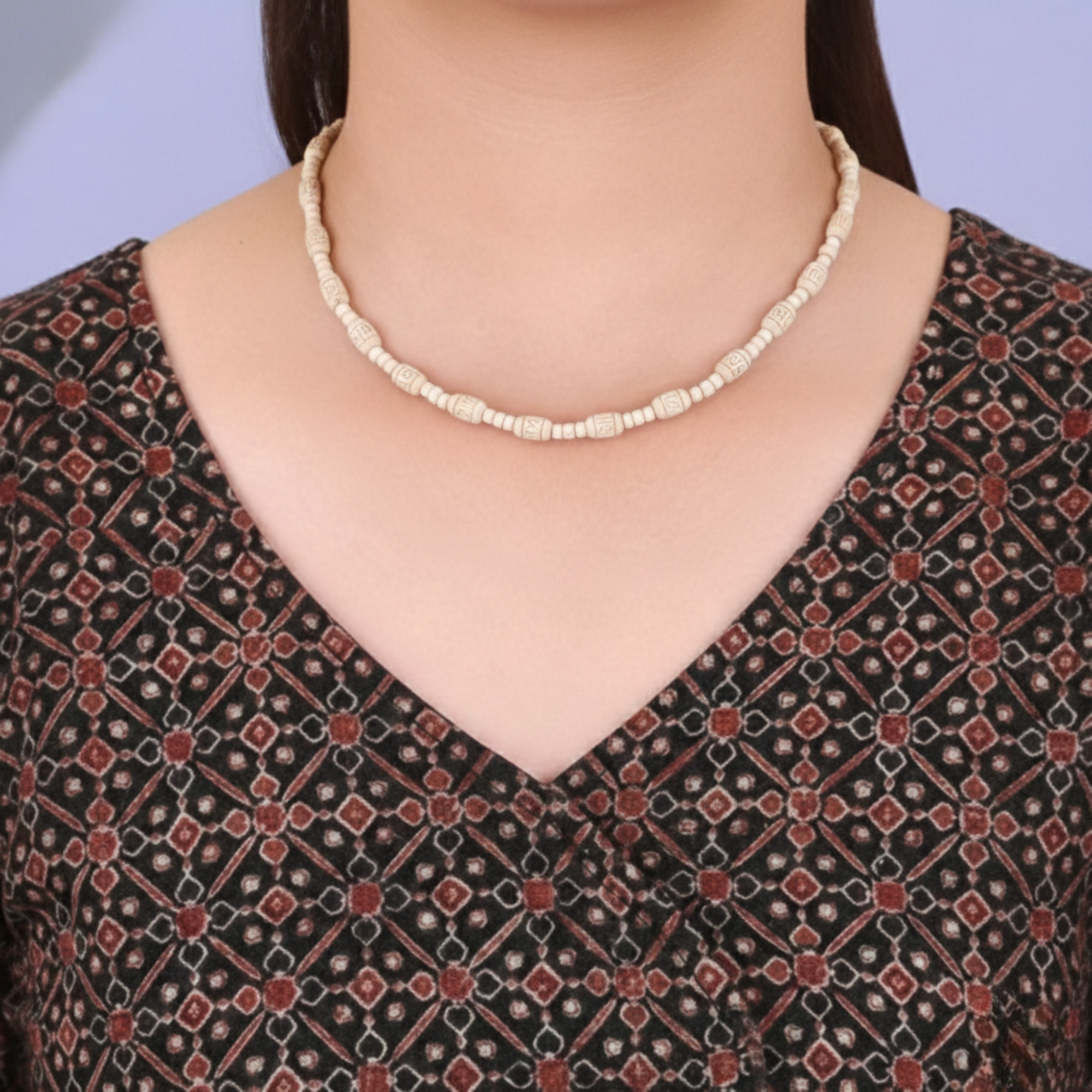 Woman wearing a handcrafted Tulsi kanthi mala with carved barrel beads around her neck