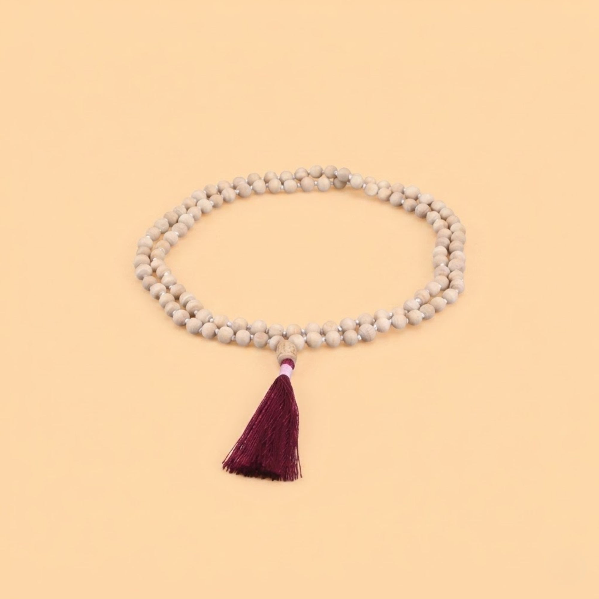 Close up of a premium authentic Tulsi japa mala with red tassel