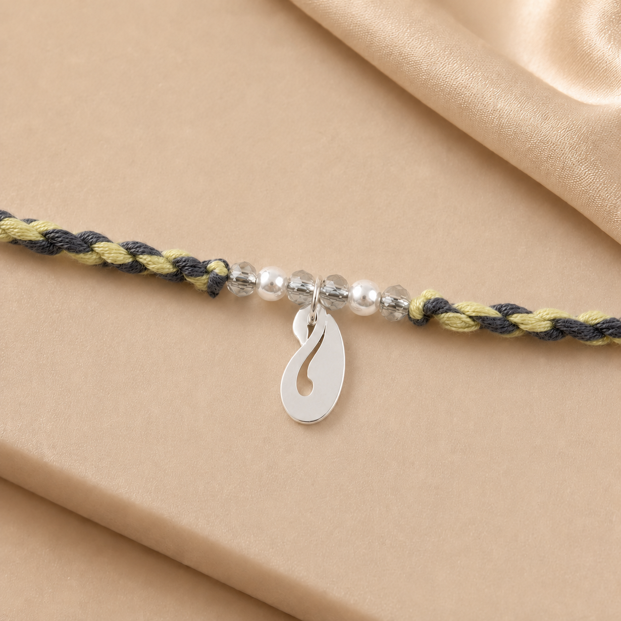 Close up view of curved pure silver peacock motif charm with white pearl accents