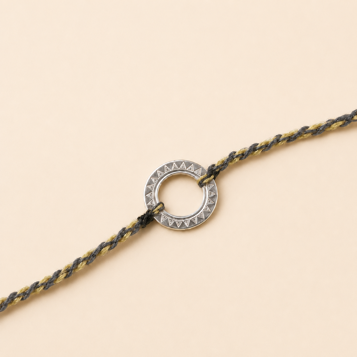 Close up view of engraved geometric open ring circle charm in 925 sterling silver