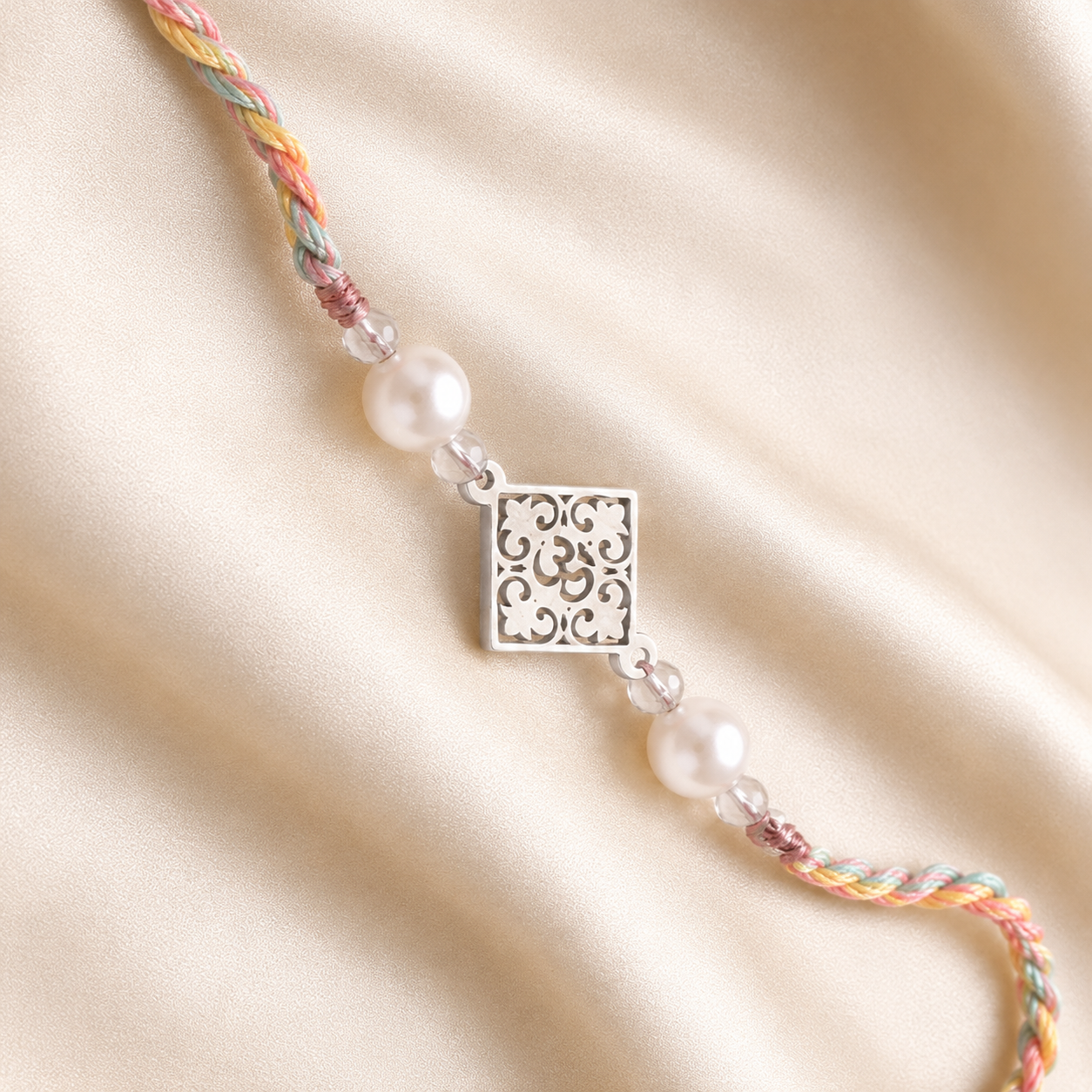 Close up view of 925 sterling silver Om filigree floral openwork charm with pearl beads