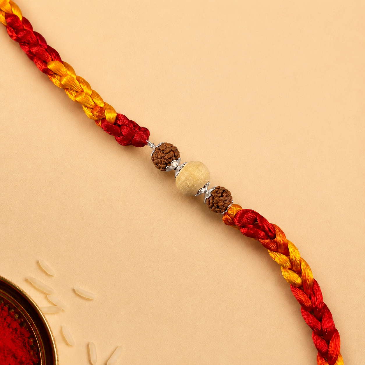 Close up view of 925 sterling silver capped round Tulsi and Rudraksha beads on red and yellow dori
