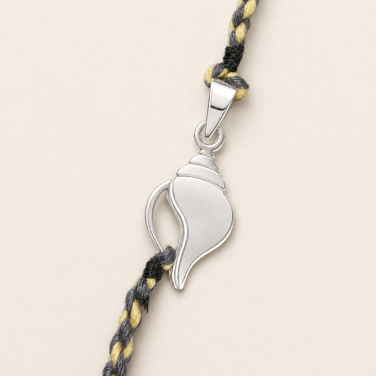 Close up view of sculpted 925 sterling silver Shankh conch shell charm centerpiece