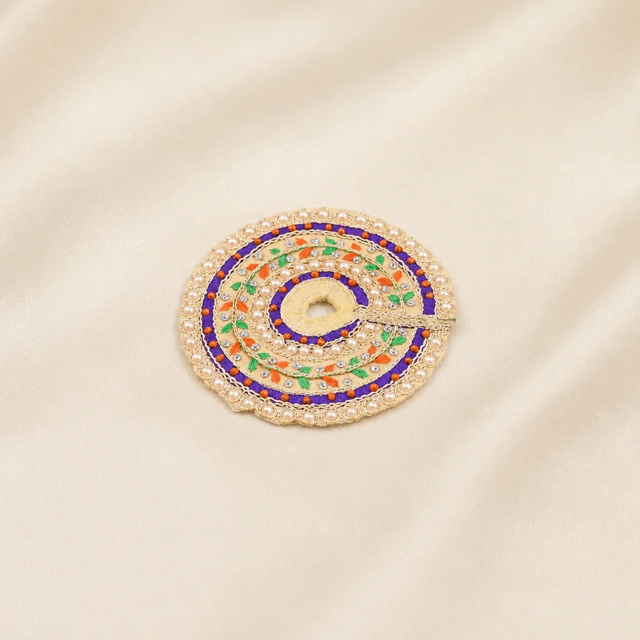 Cream and purple Laddu Gopal dress with colourful leaf embroidery, decorative stones and pearl detailing.