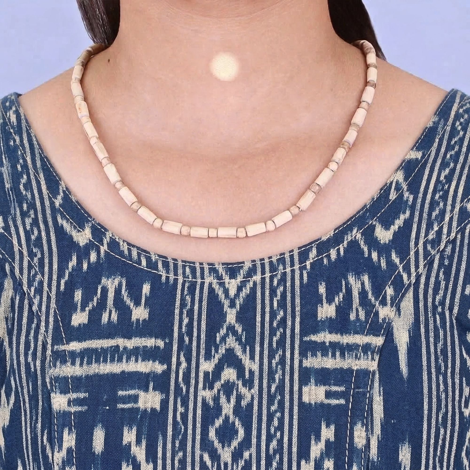 Woman wearing a handmade Tulsi kanthi mala with cylindrical shaped beads around her neck