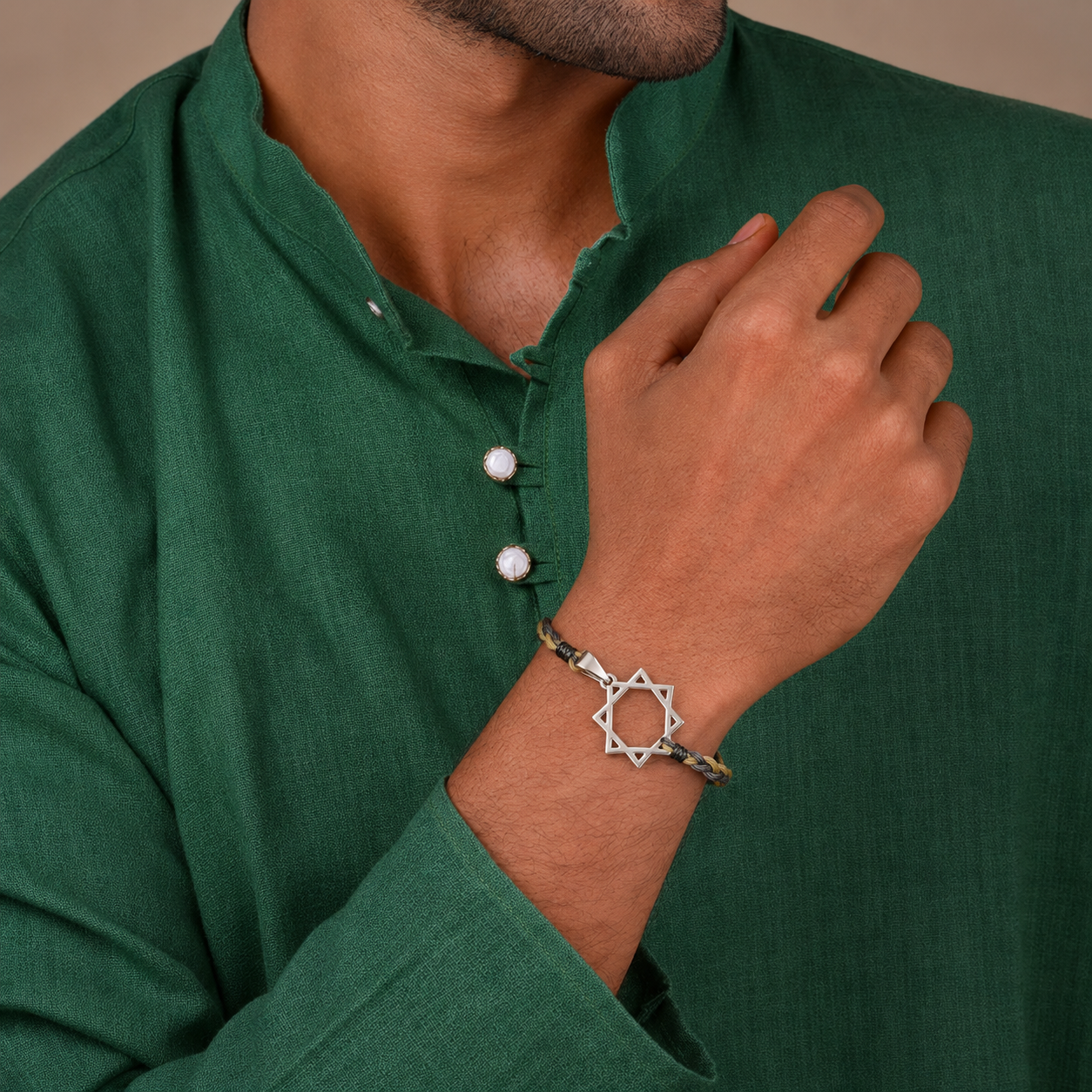 Brother wearing designer geometric star silver rakhi bracelet with dark green kurta