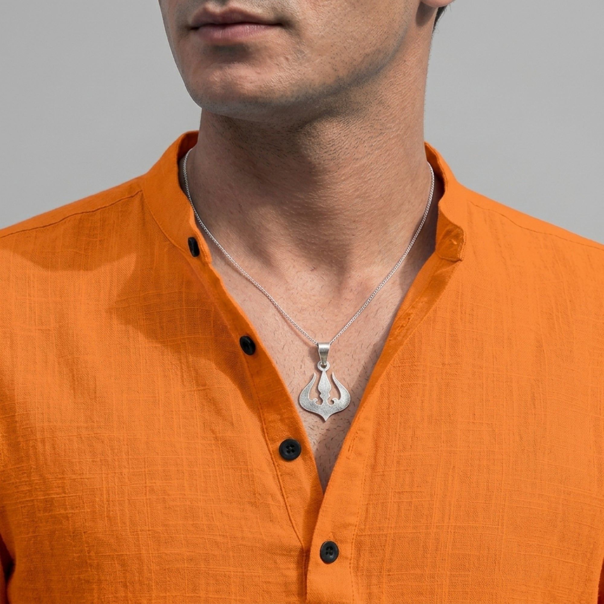 Model wearing divine 925 pure silver Trishul pendant for men and women with saffron shirt
