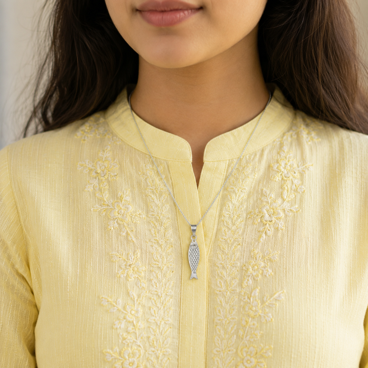 Woman wearing divine Matsya pure silver pendant necklace with yellow kurti