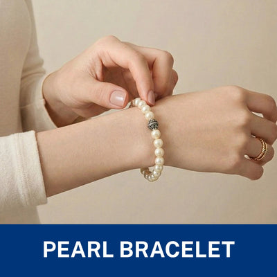 Elegant pearl beaded bracelet featuring a single detailed silver-toned spacer bead.