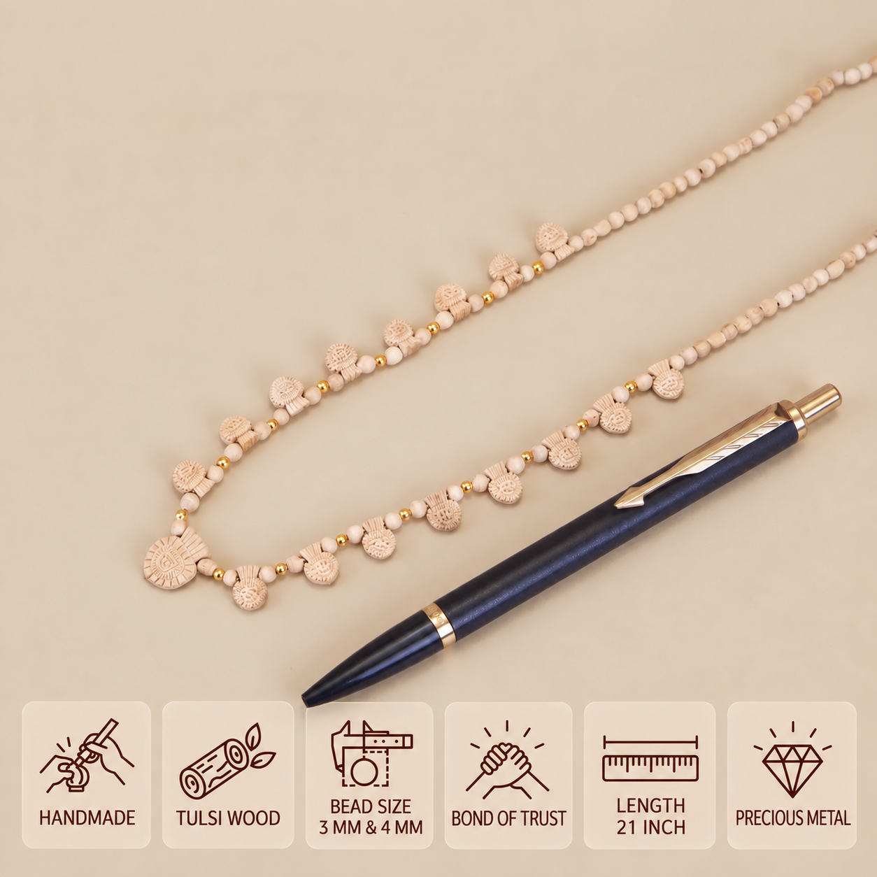 Tulsi bead necklace with carved hanging charms and gold spacers beside a pen, showing 3 mm and 4 mm beads and a 21 inch length.