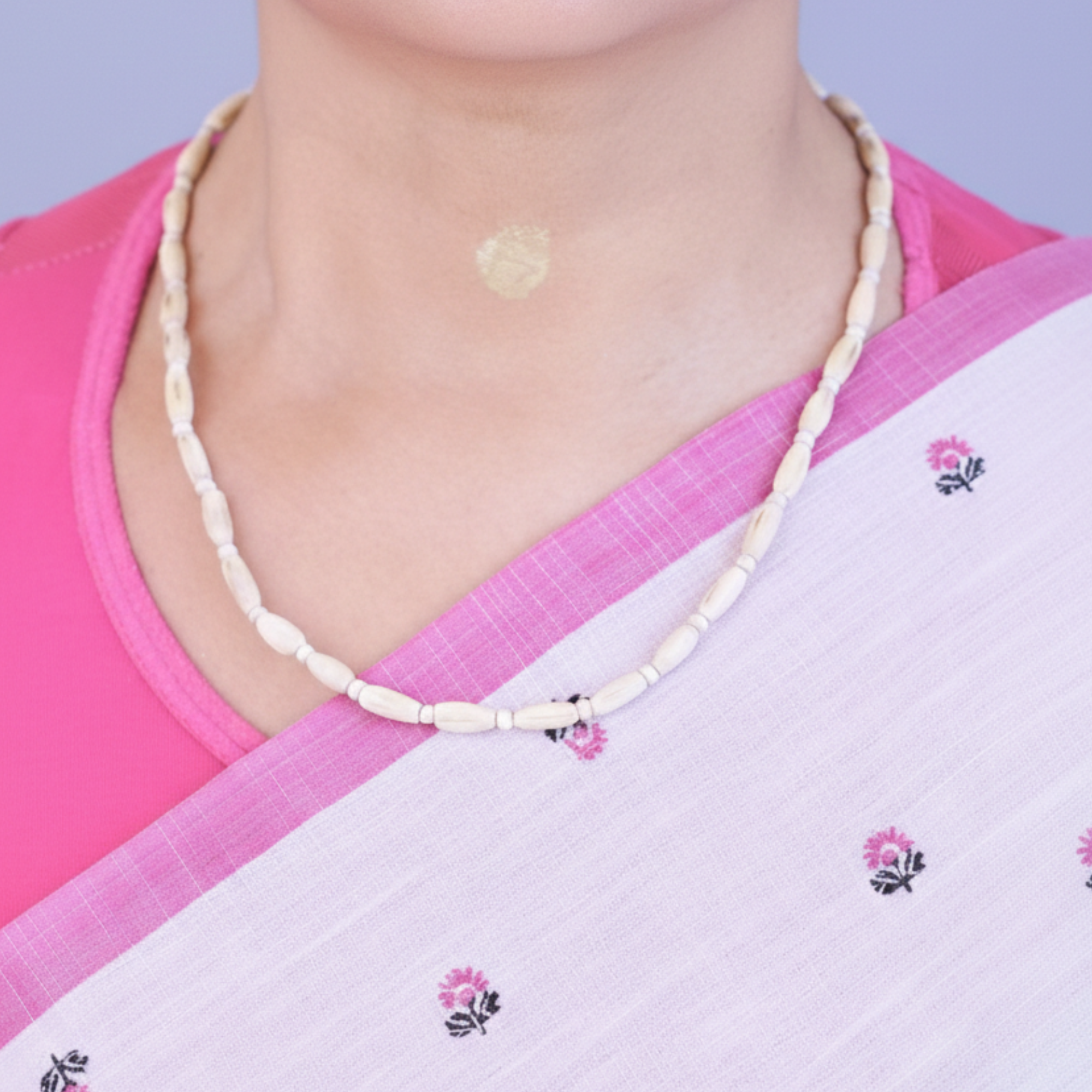 Woman wearing a handcrafted Tulsi kanthi mala with oval beads sourced from Vrindavan