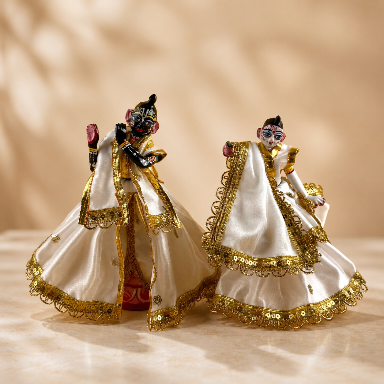 Side view of handcrafted white and gold dress for Radha Krishna deities