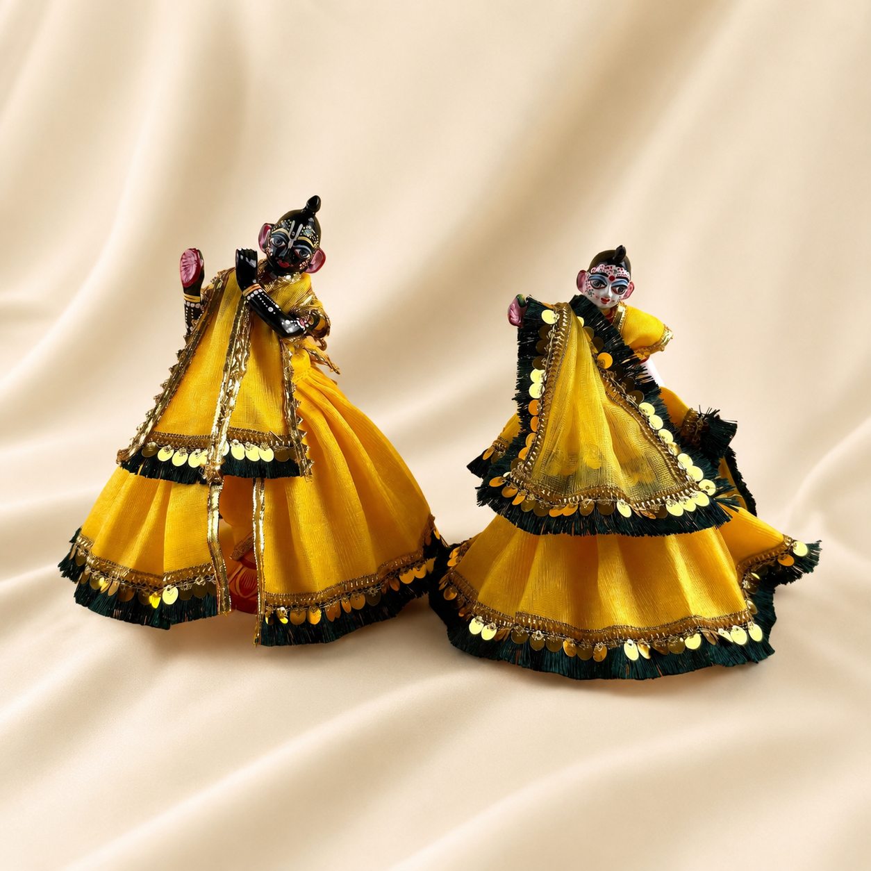 Side view of handcrafted yellow and gold dress for Radha Krishna deities
