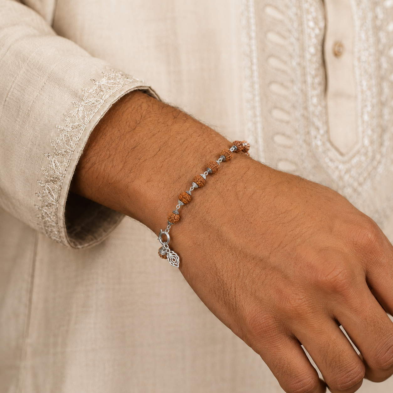 Handcrafted rudraksha bracelet with silver capping worn on wrist