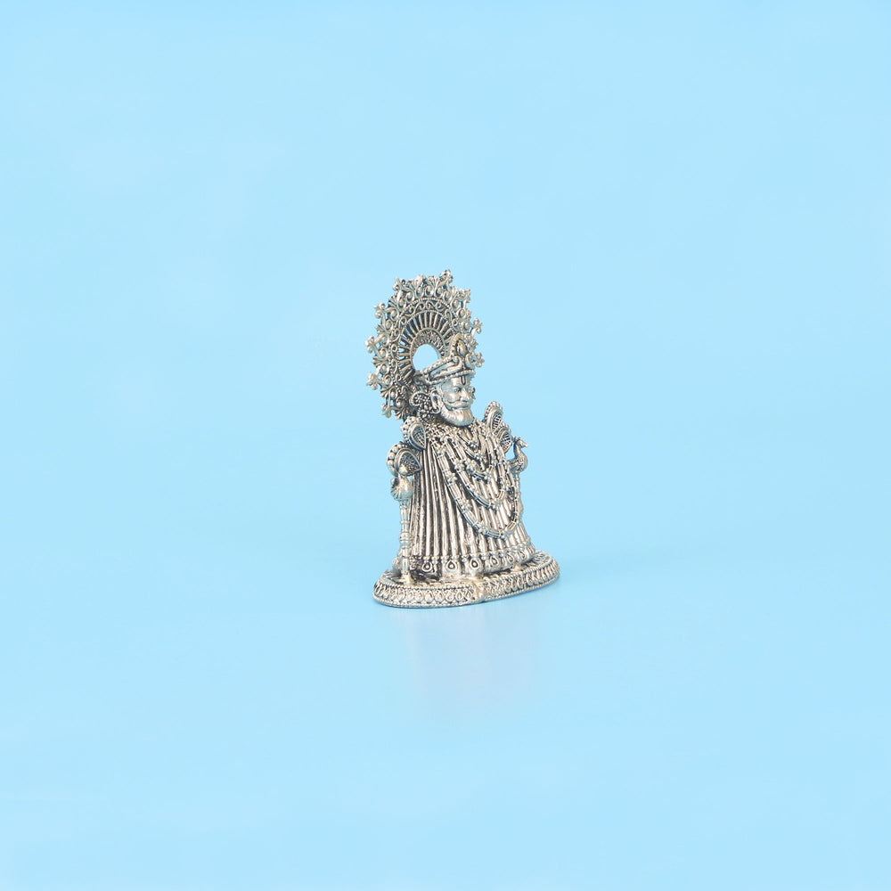 Side angle view of handcrafted pure silver Khatu Shyam Ji statue