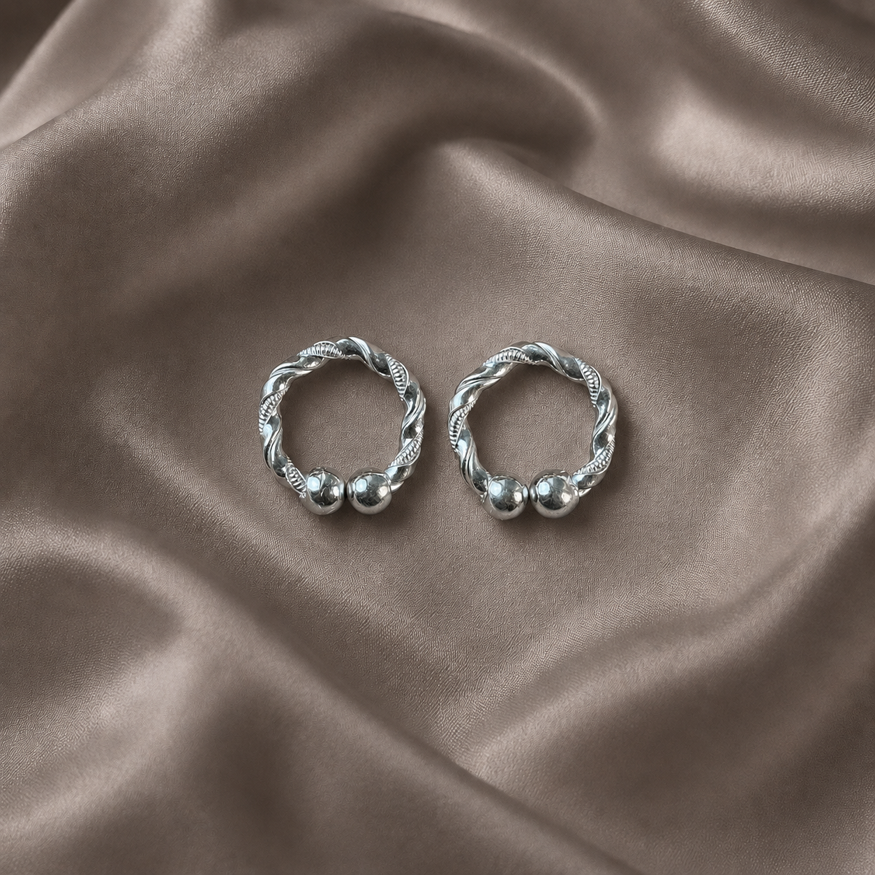 Handcrafted silver kada for deities artistic work twisted rope bangle pair on dark satin fabric