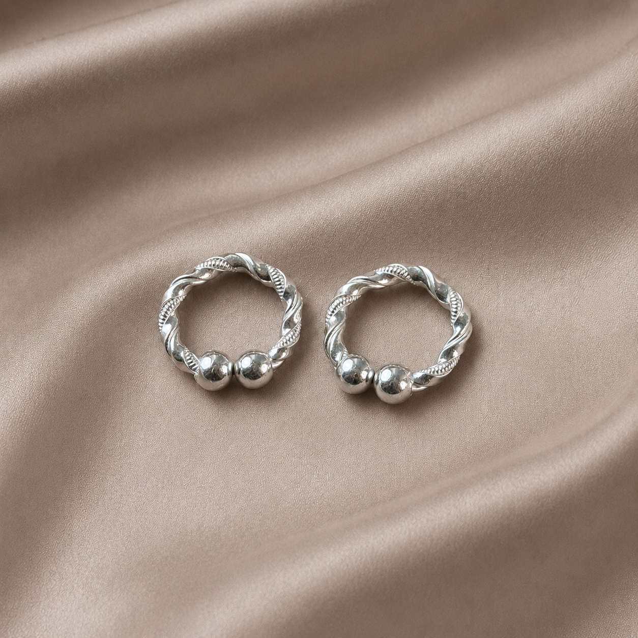 Handcrafted silver kada for Kanha Ji beautiful design twisted rope bangle pair on dark satin fabric