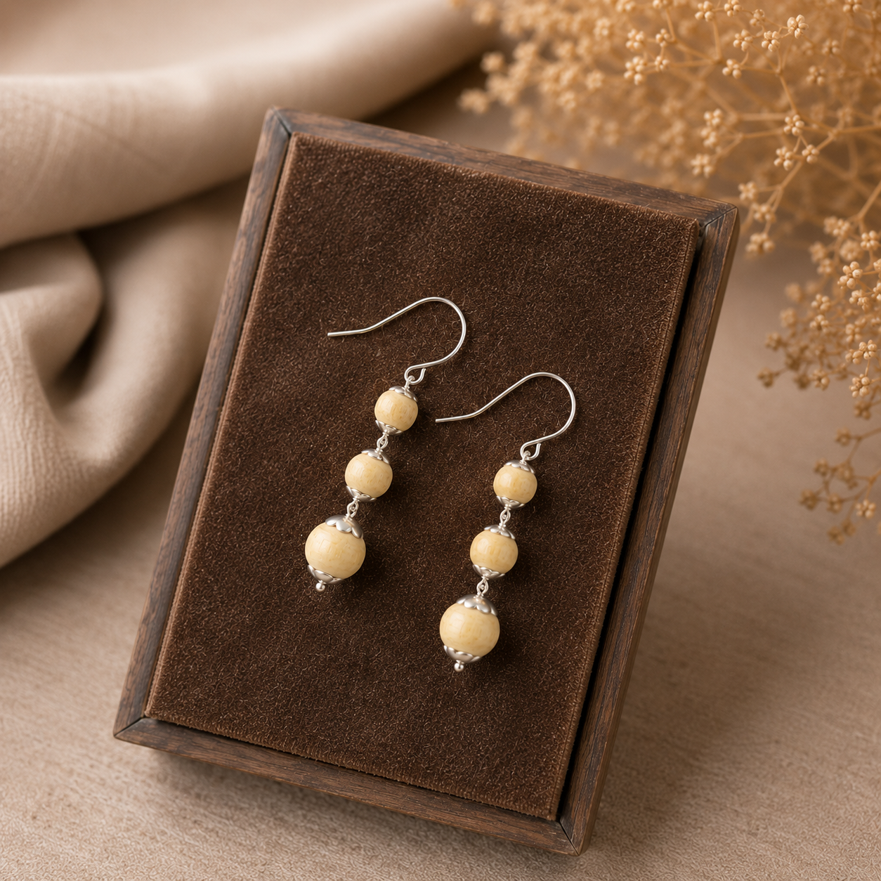 Handmade pure silver dangle earrings with natural Tulsi wood beads resting beautifully in a gift box