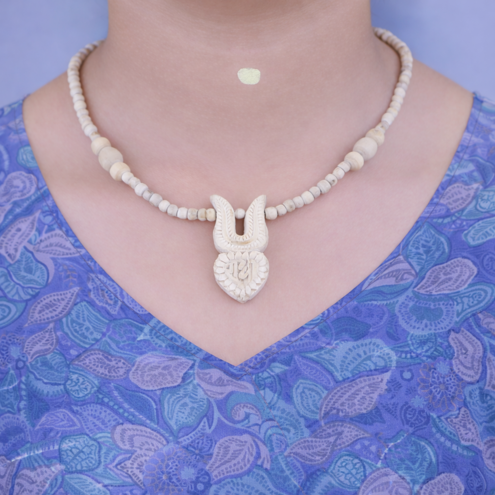 Woman wearing a traditional authentic Tulsi Kanthi Mala with a handmade Shri Radha tilak pendant