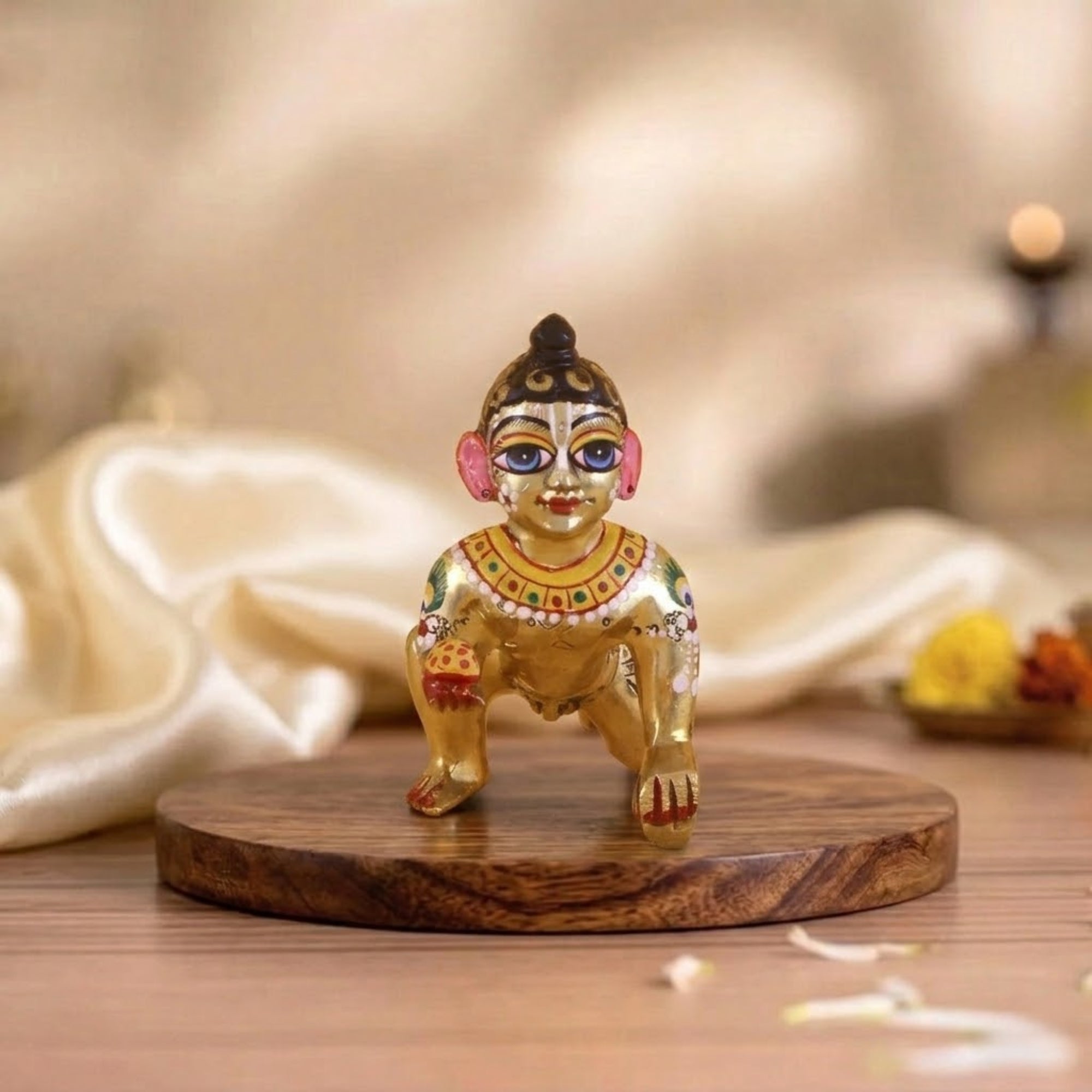 Colourful hand-painted small Laddu Gopal Ashtadhatu idol displayed on a wooden base