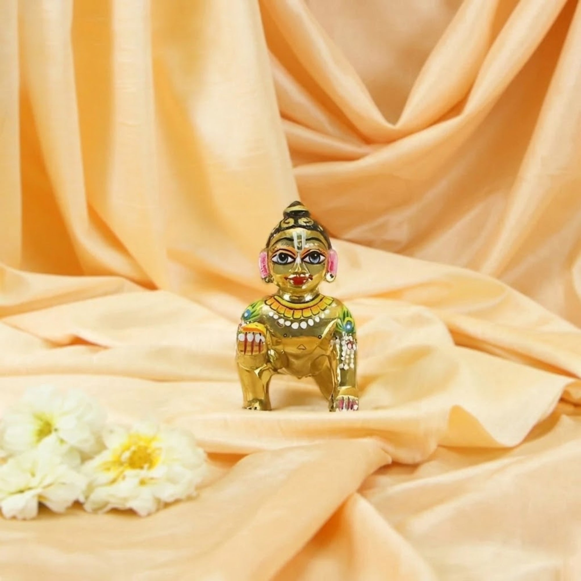 Attractive design heavy-weighted Laddu Gopal Ashtadhatu idol of Kanha Ji displayed on soft silk