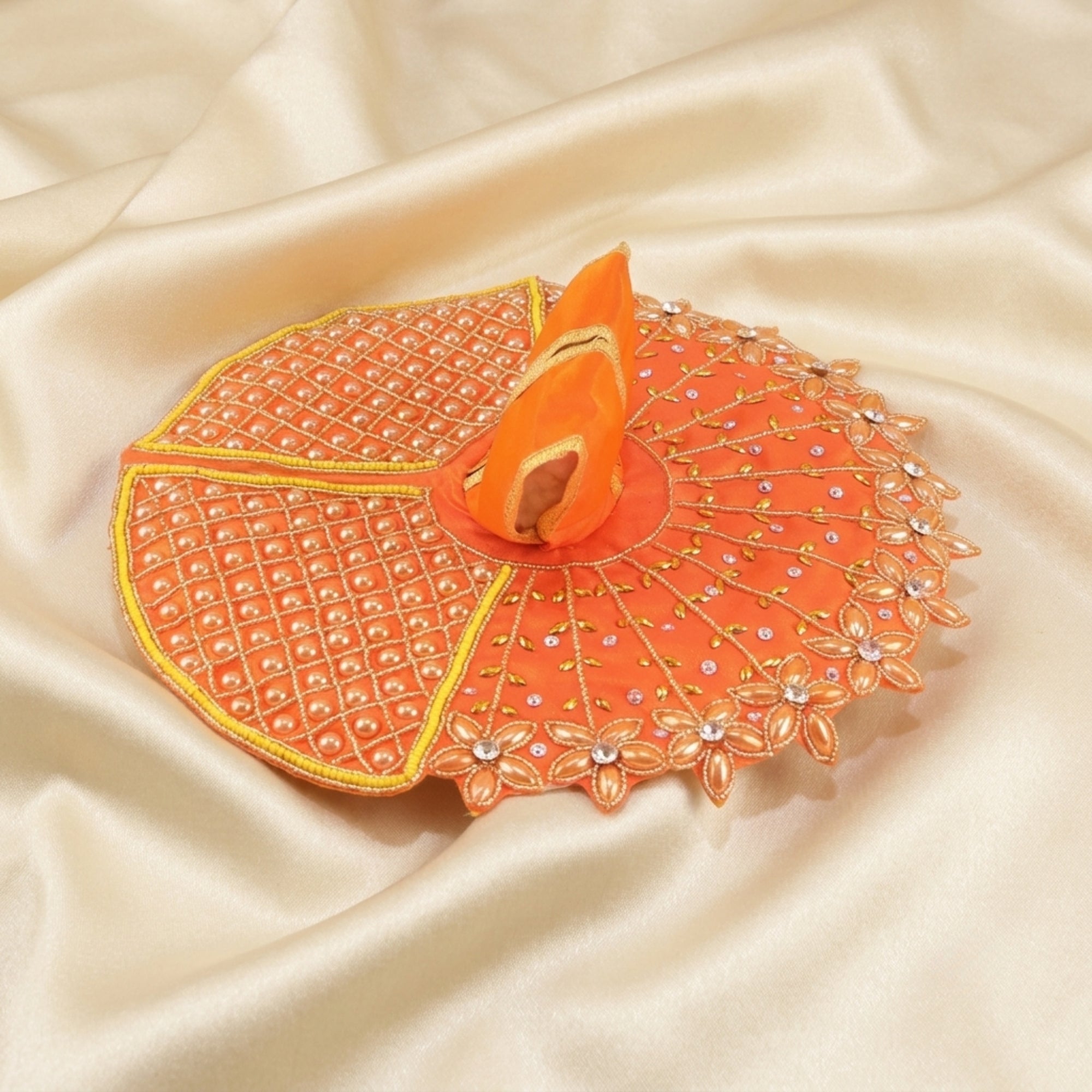 Laddu Gopal orange dress with handcrafted golden stone floral design displayed flat