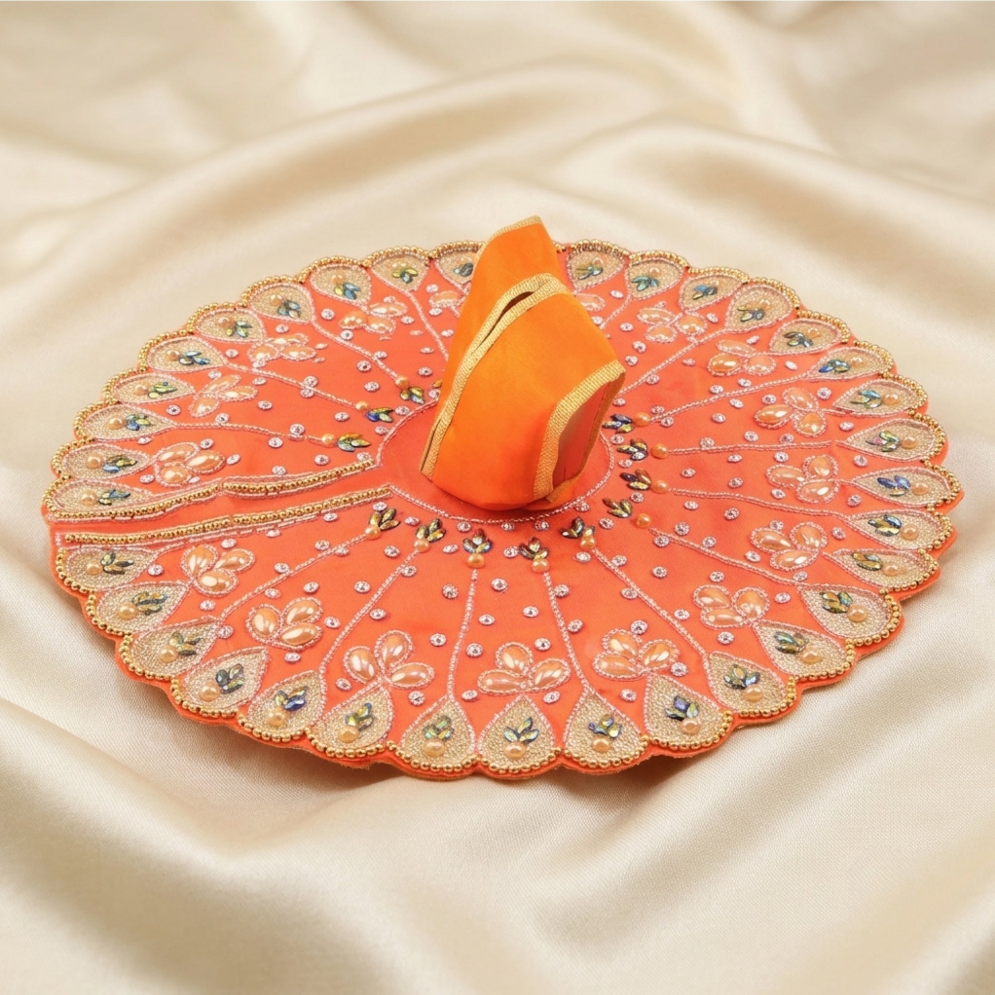 Laddu Gopal orange dress with handcrafted peacock design displayed flat