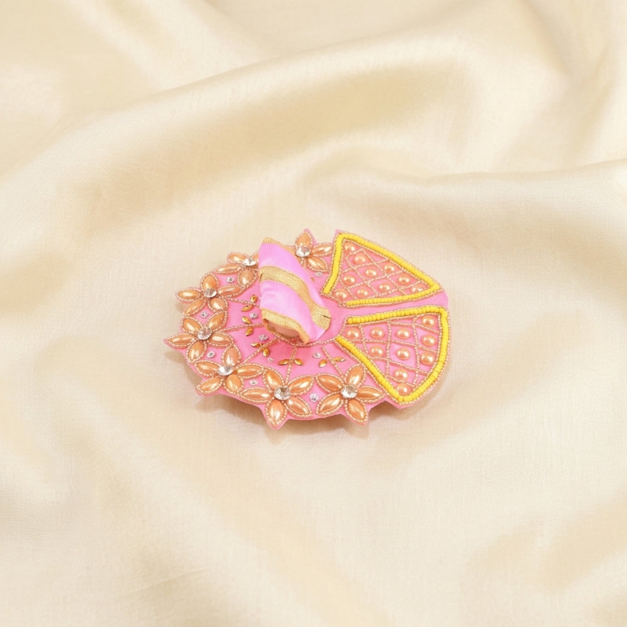 Laddu Gopal pink dress with handcrafted golden floral design displayed flat