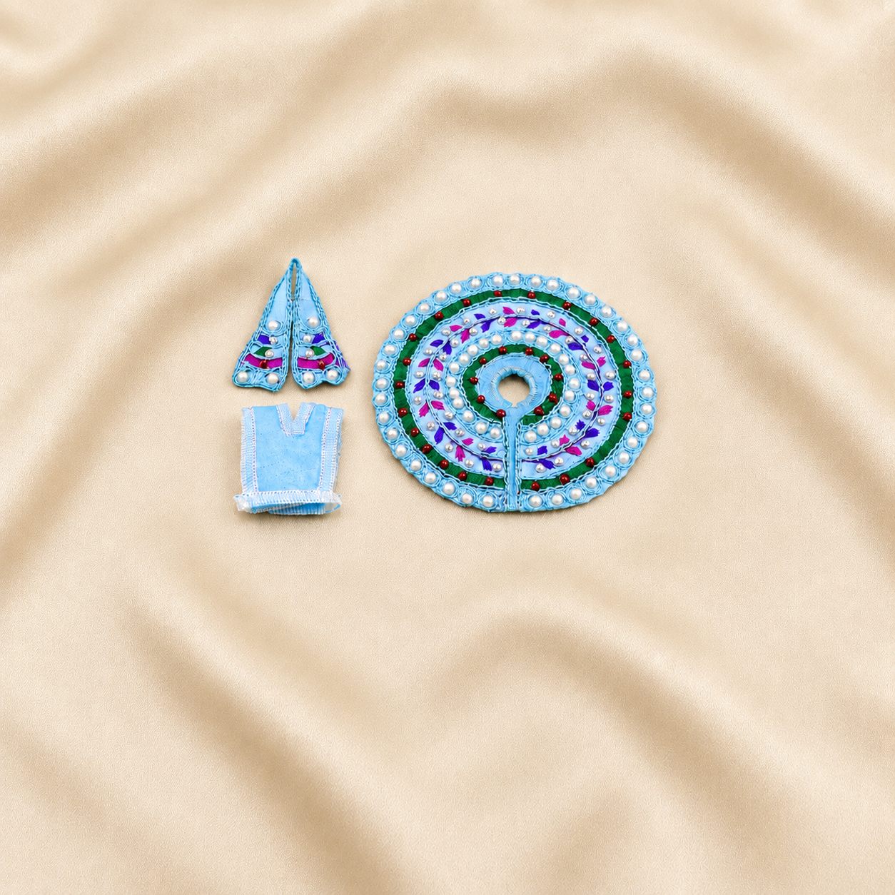 Light blue Laddu Gopal dress set with pearl decoration and matching accessories.