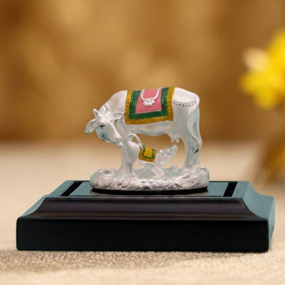 mere krishna silver-plated Kamdhenu cow and calf idol on a decorative black base