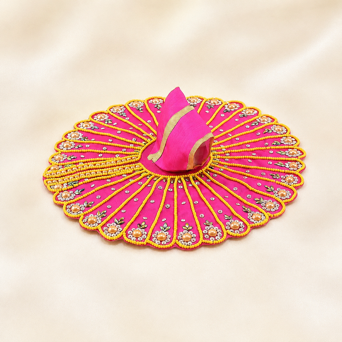 pink Laddu Gopal dress with yellow beadwork, pearl floral accents, rhinestones and gold-trimmed matching garment