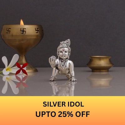 merekrishna silver Krishna idol displayed with a traditional brass lamp and up to 25% off offer