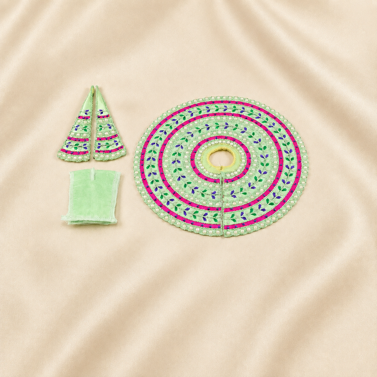 Mint green Laddu Gopal dress set with pink bands, pearl work and matching accessories.
