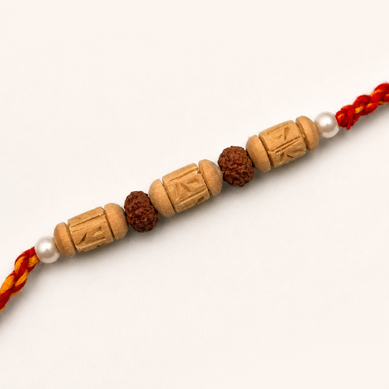  sacred multi-bead Tulsi and Rudraksha Rakhi onto her brother's wrist