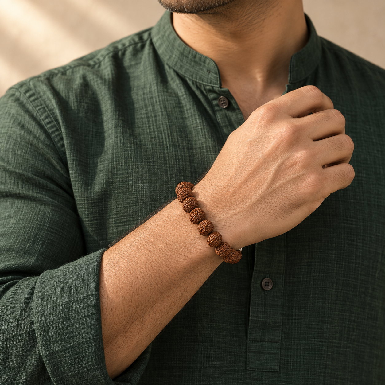 Man wearing a natural rudraksha bracelet with textured rudraksha beads