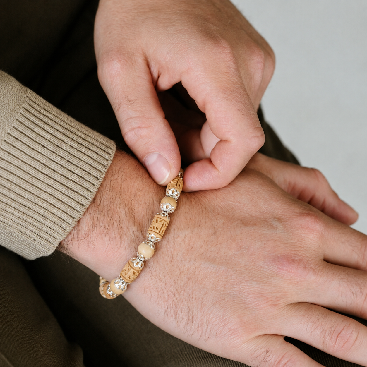 Man wearing natural Tulsi bracelet with original 8 mm Tulsi beads and pure silver detailing