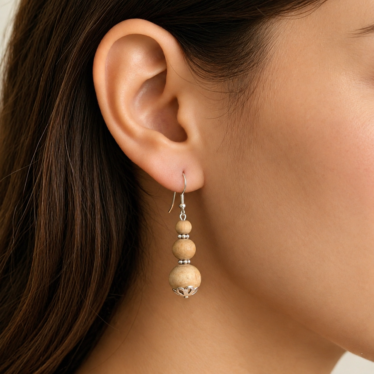 Woman wearing natural Tulsi earrings with three Tulsi beads and pure silver-tone hook 