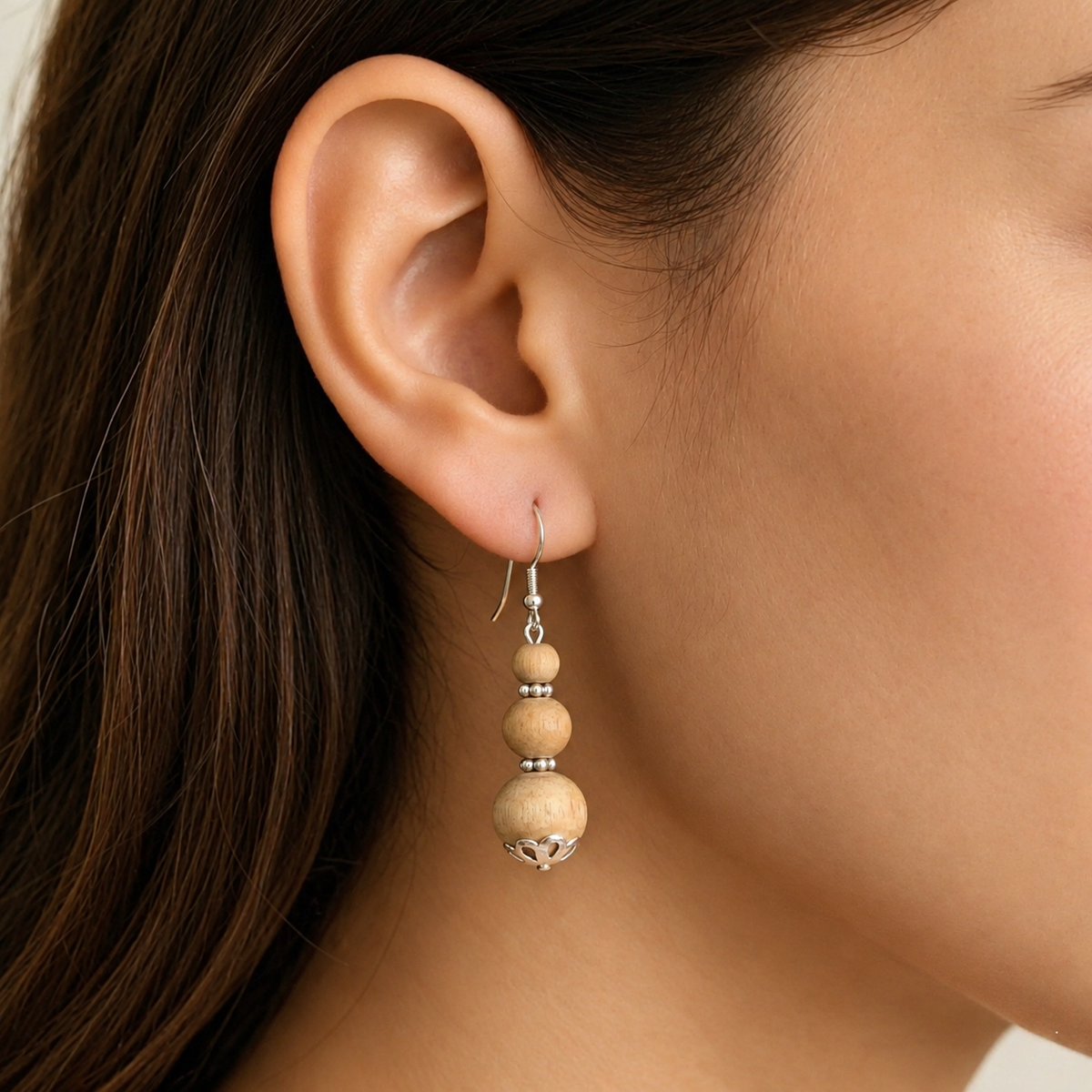 Woman wearing natural Tulsi earrings with three Tulsi beads and pure silver-tone hook 