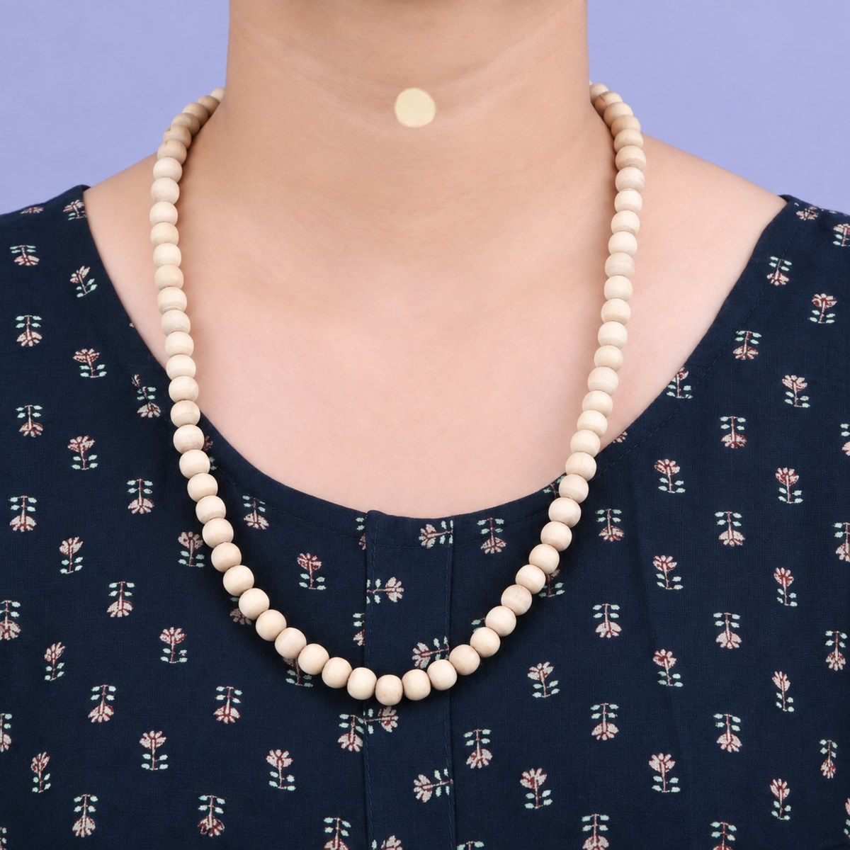 Woman wearing natural Tulsi Mala with original 6 mm Tulsi beads and 21 inch length