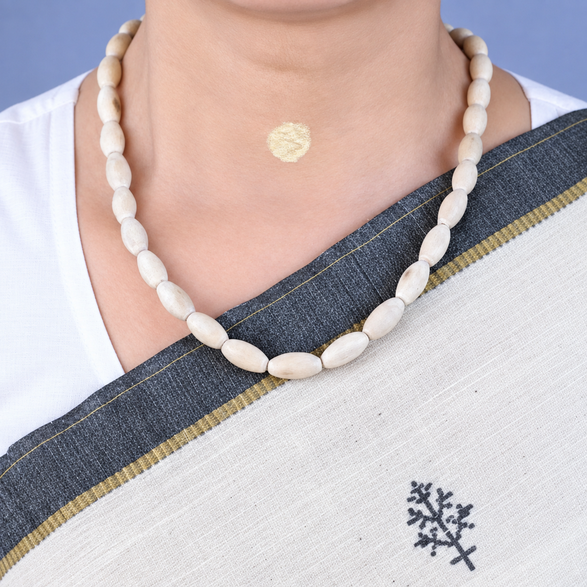 Woman wearing natural Tulsi Mala with original handmade Tulsi beads in a traditional necklace style