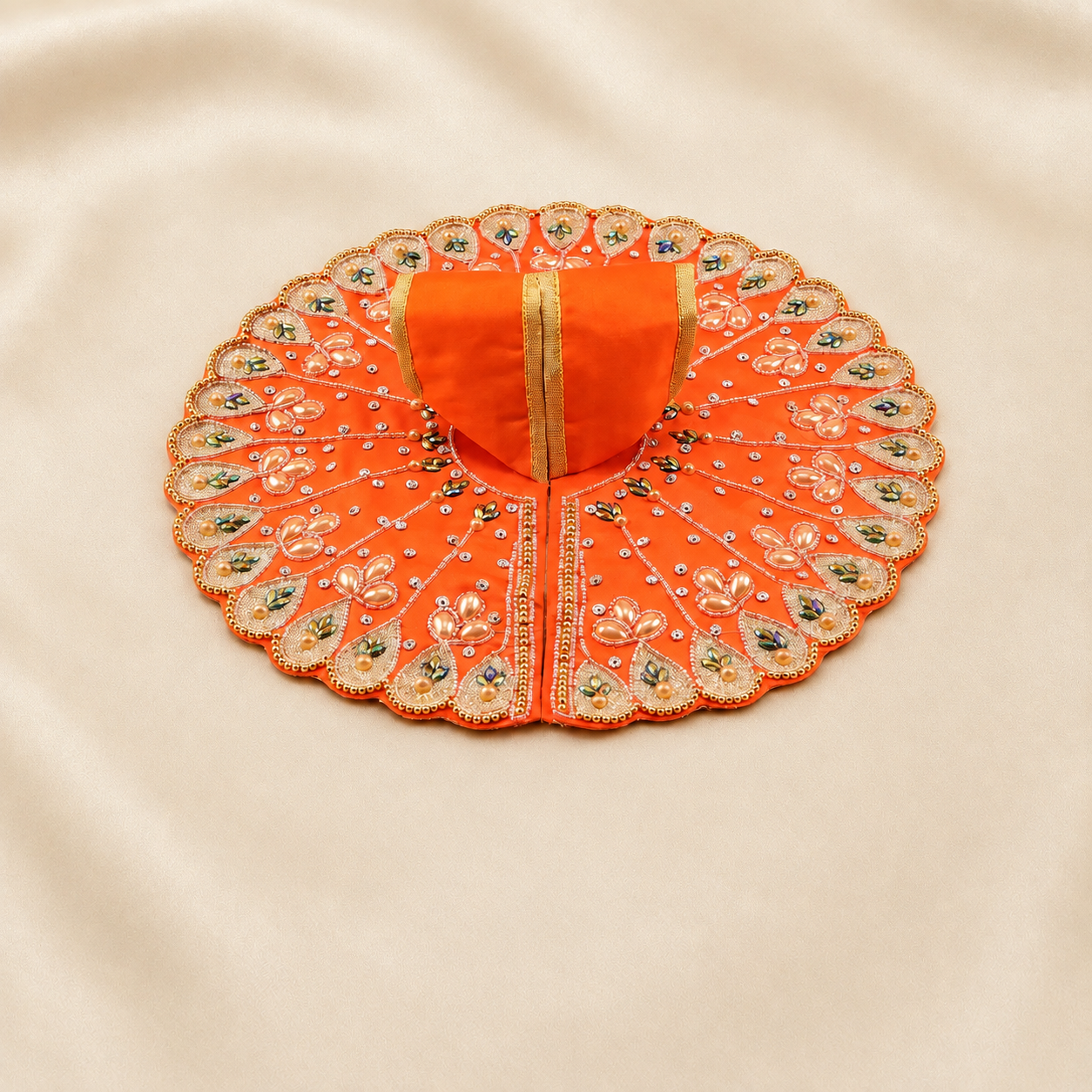 Orange Laddu Gopal dress with golden floral border and pearl grid detailing.