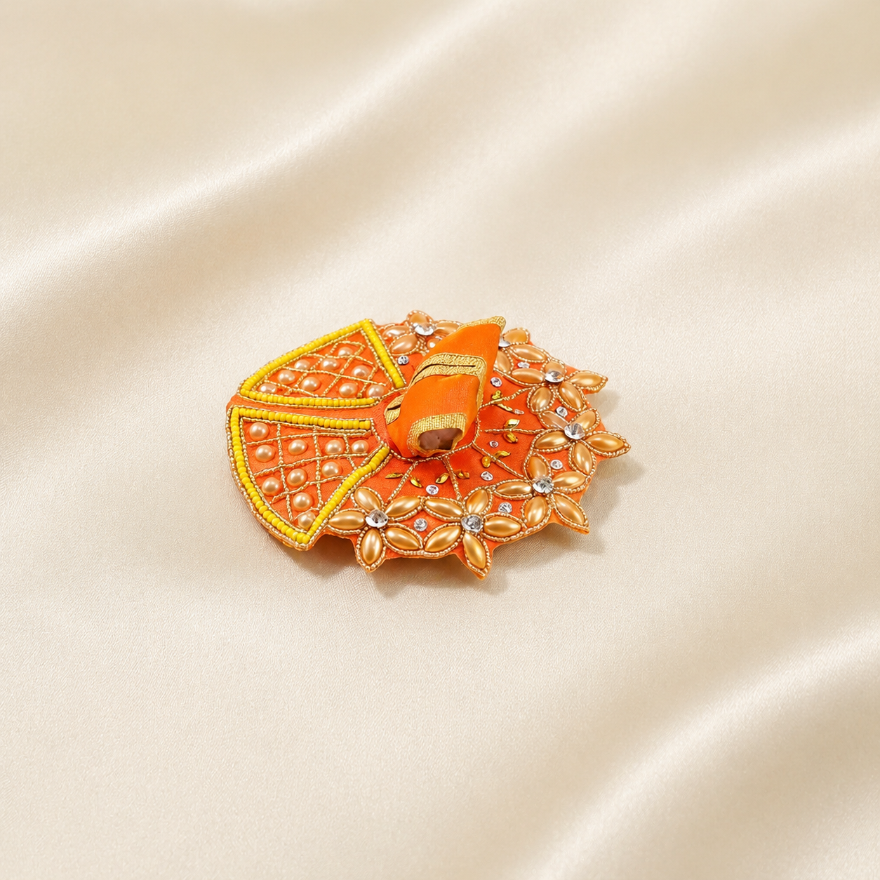Orange Laddu Gopal dress with pearl floral work, yellow bead border, crystal stones and golden embroidery.