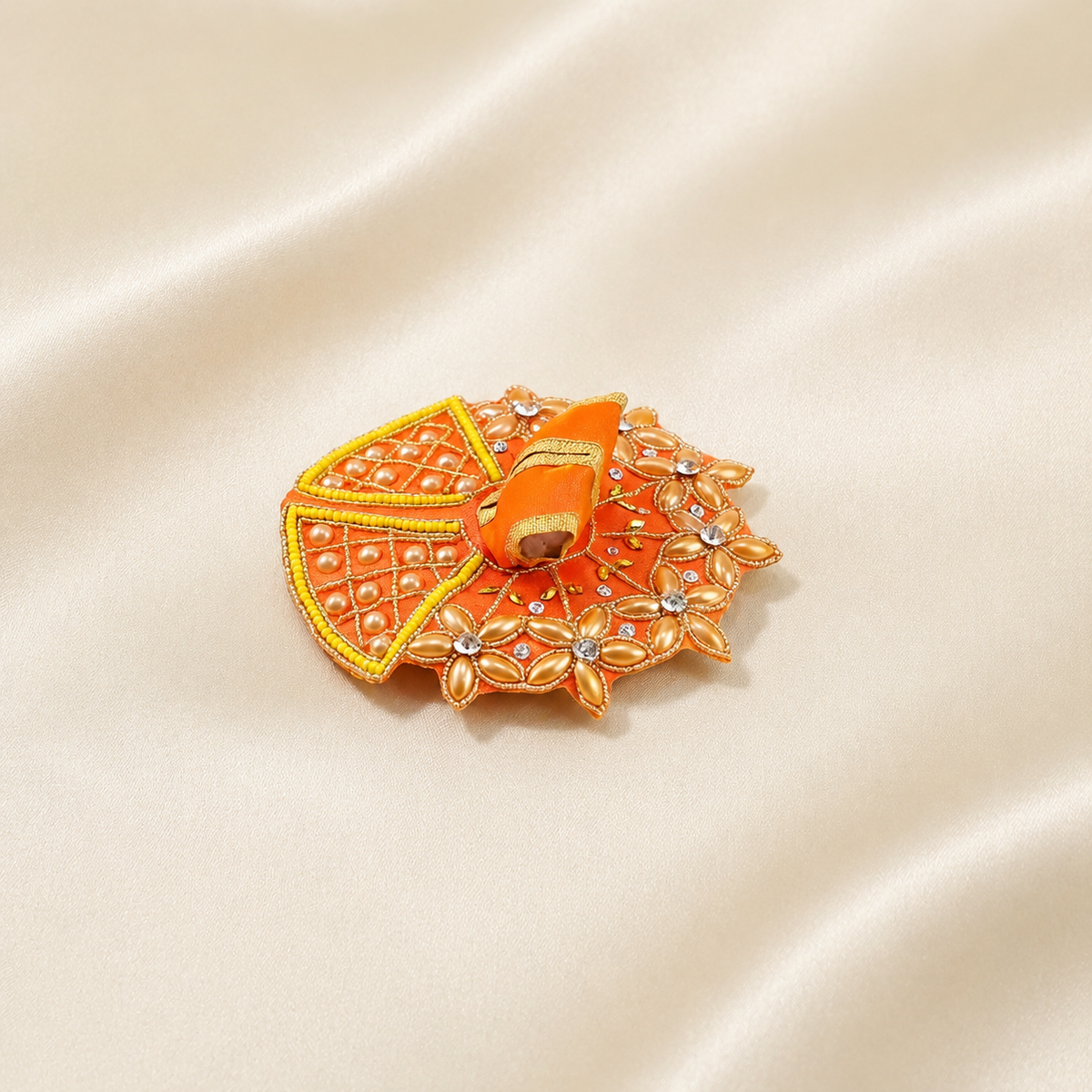 Orange Laddu Gopal dress with pearl floral work, yellow bead border, crystal stones and golden embroidery.