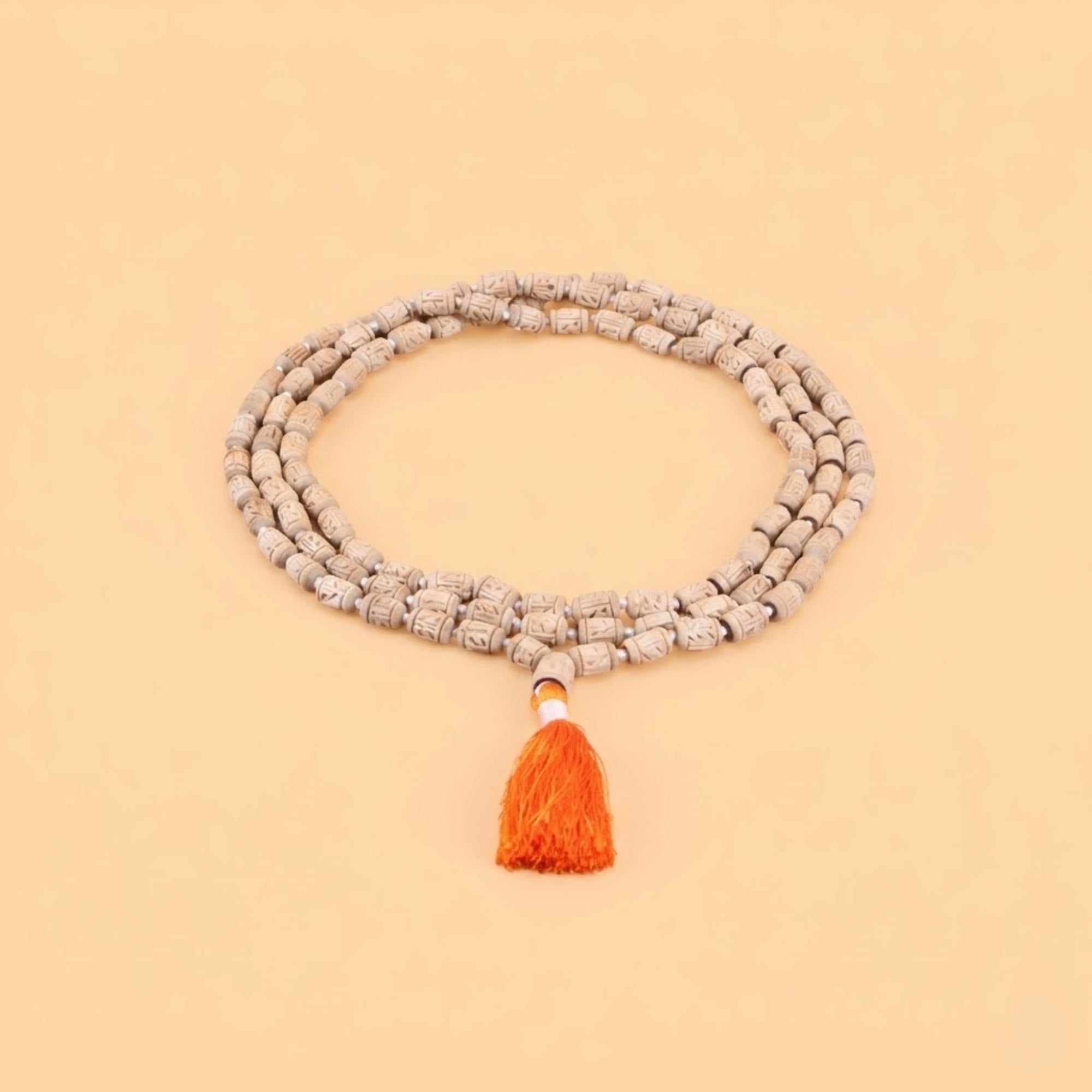 Close up of intricately hand-carved authentic Tulsi wood beads on a premium japa mala