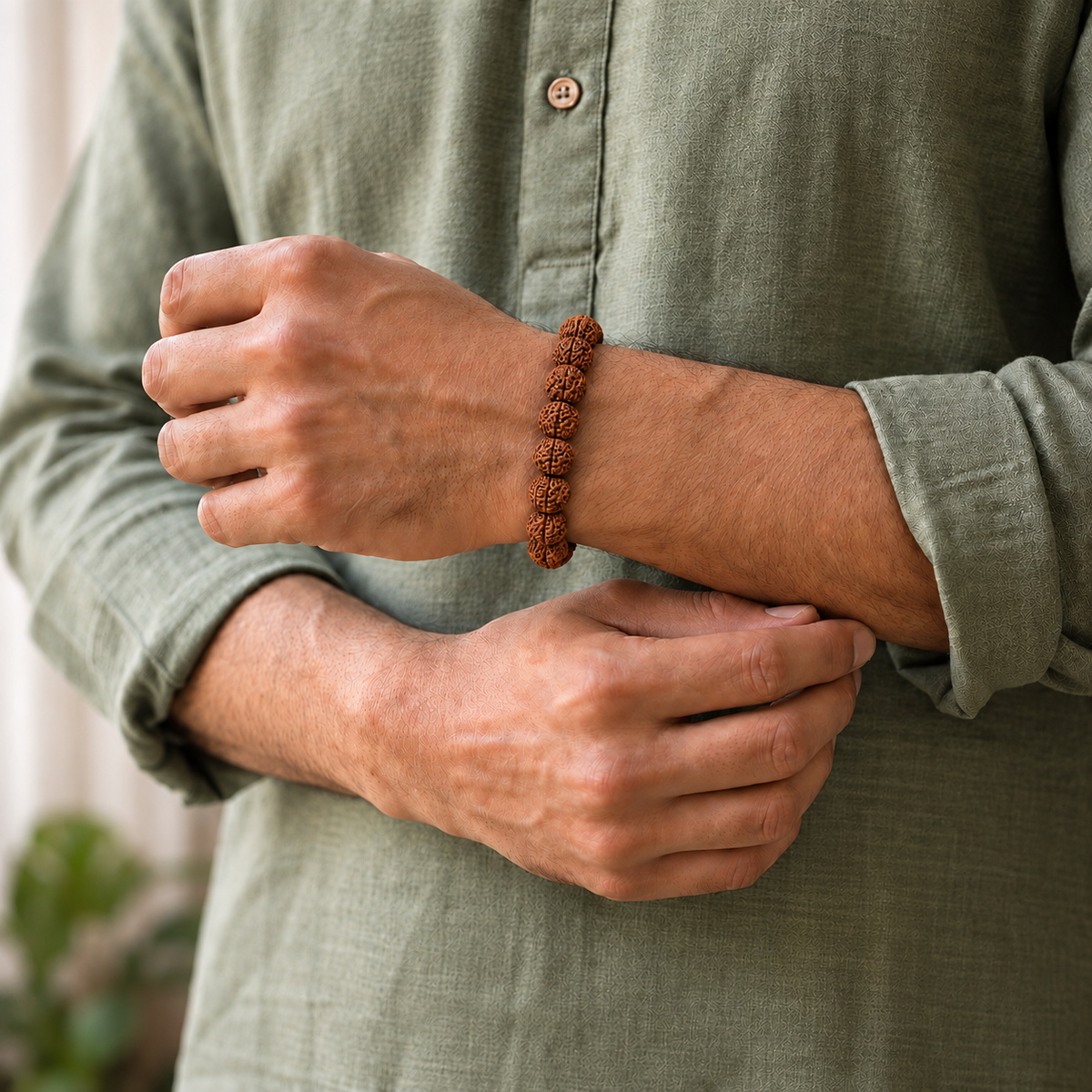 Original rudraksha bracelet for men featuring natural textured rudraksha beads and a silver magnetic clasp, worn on the wrist