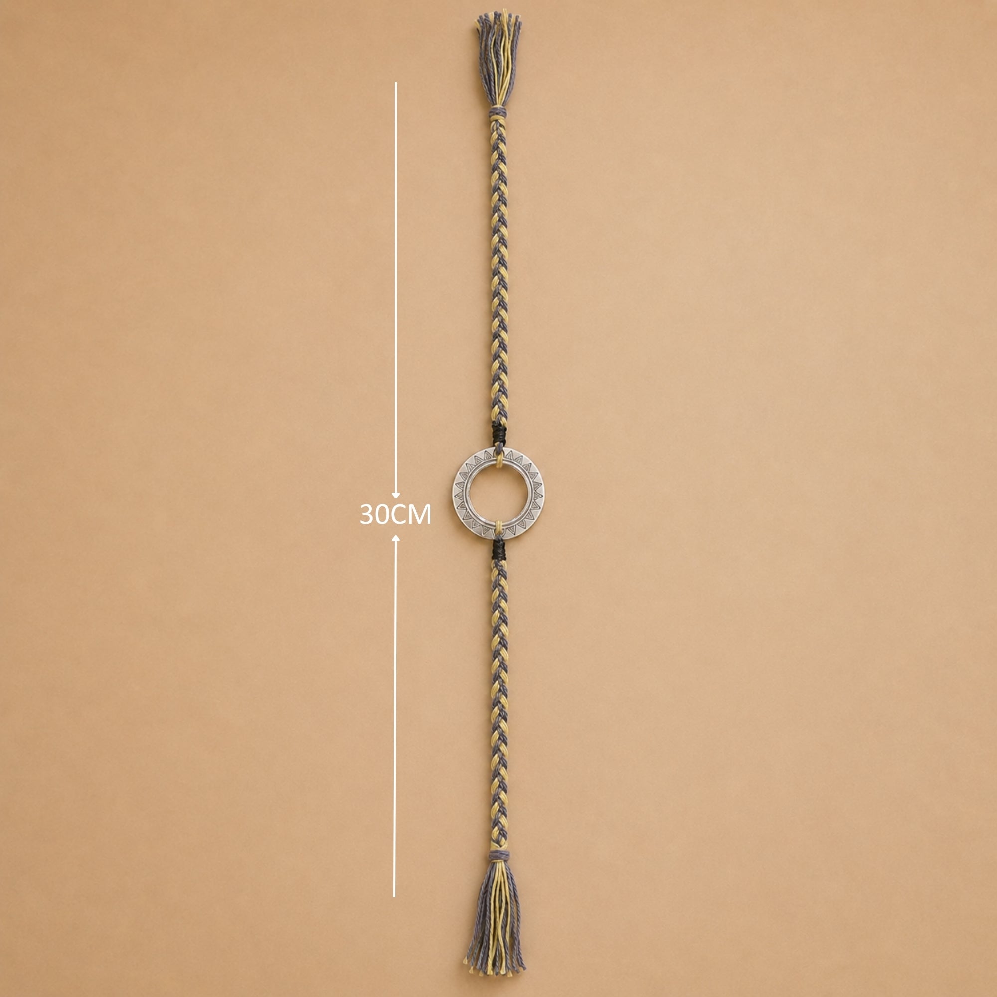 Full length view showing thread layout and tassels of original silver round circle rakhi