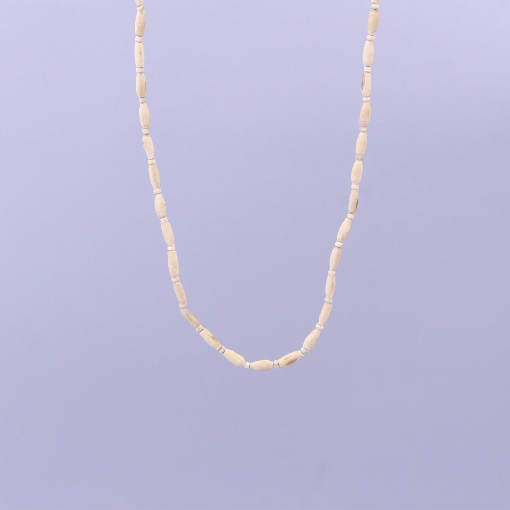 Close up of pure wooden oval beads on a handcrafted Vrindavan Tulsi neck mala